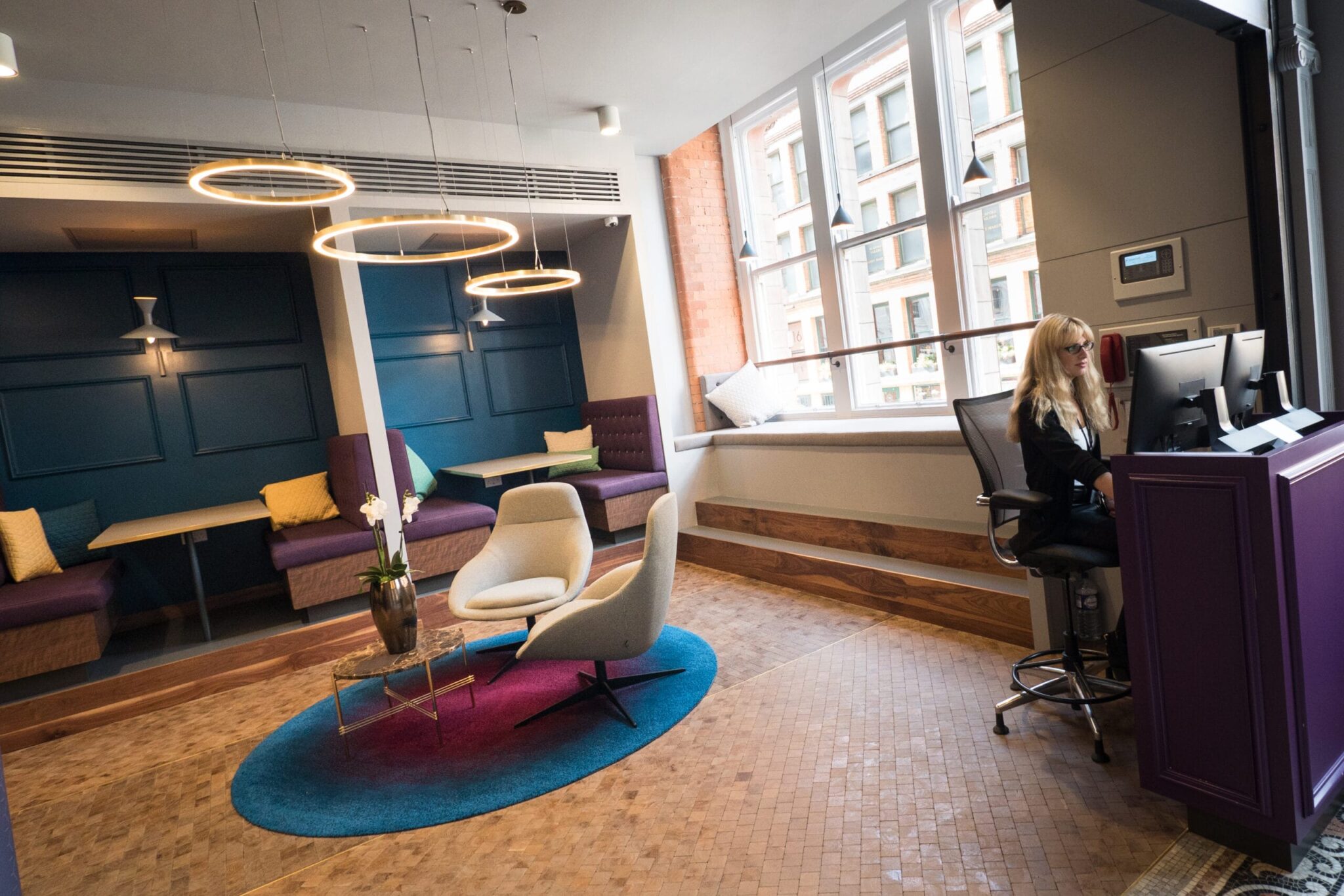 Modern hanging light fixtures create a more relaxing workplace atmosphere.