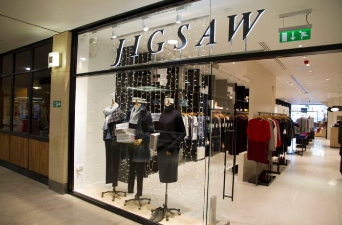Spotlights accentuate shop signs to improve visibility.